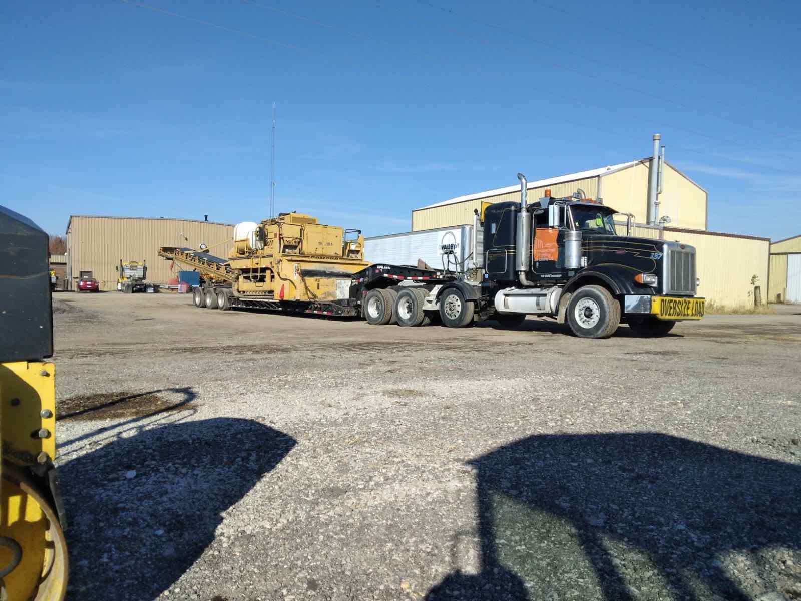 Truck and trailer in the yard outside the shop